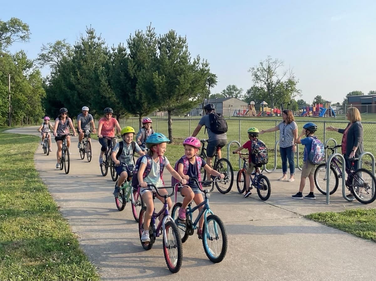 Children arriving at school by bike with parents during a bike train