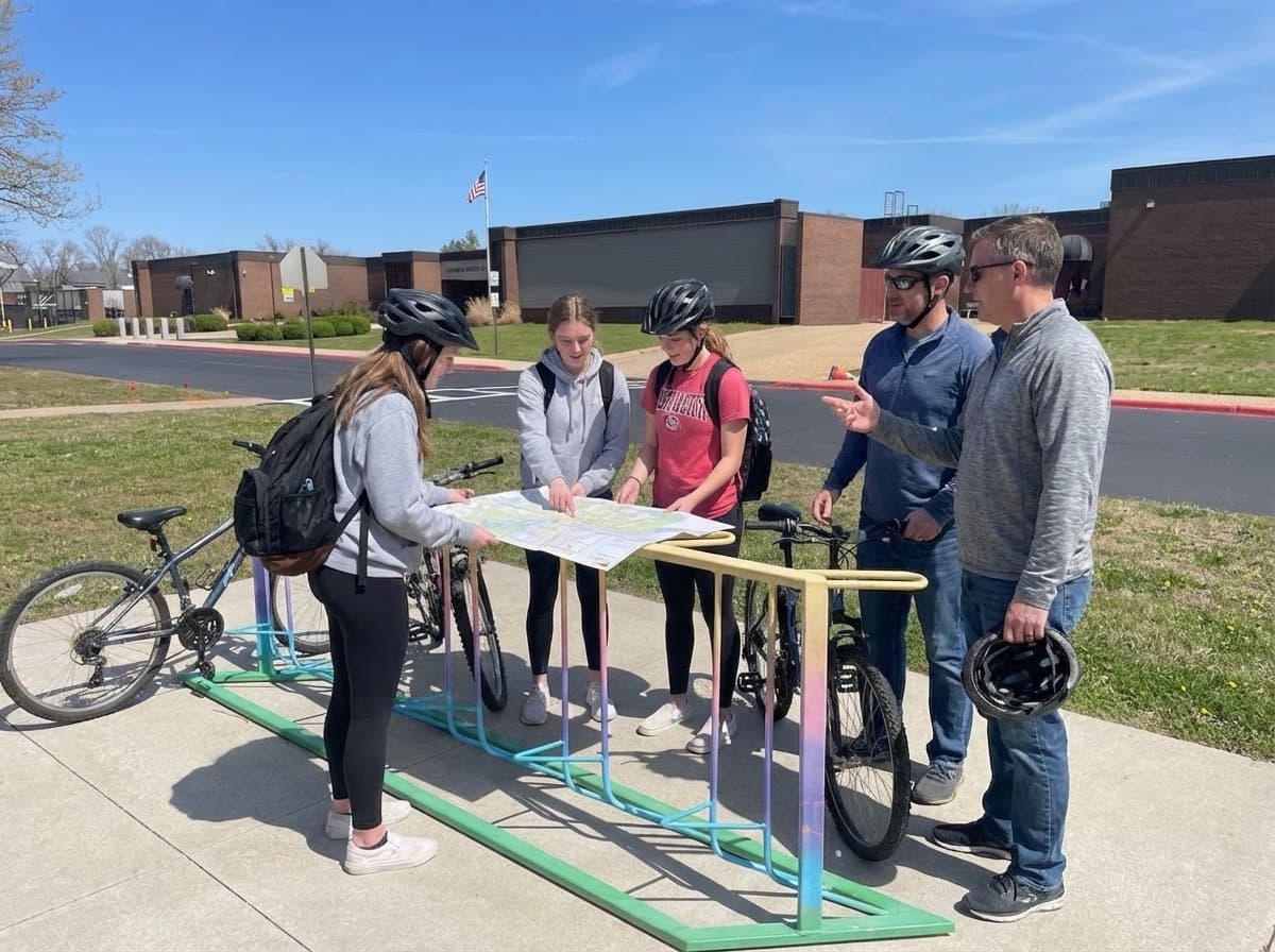 Parents and students with bicycles at a school event